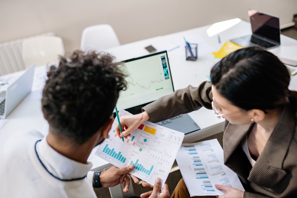 Marketing team analyzing performance data and campaign charts